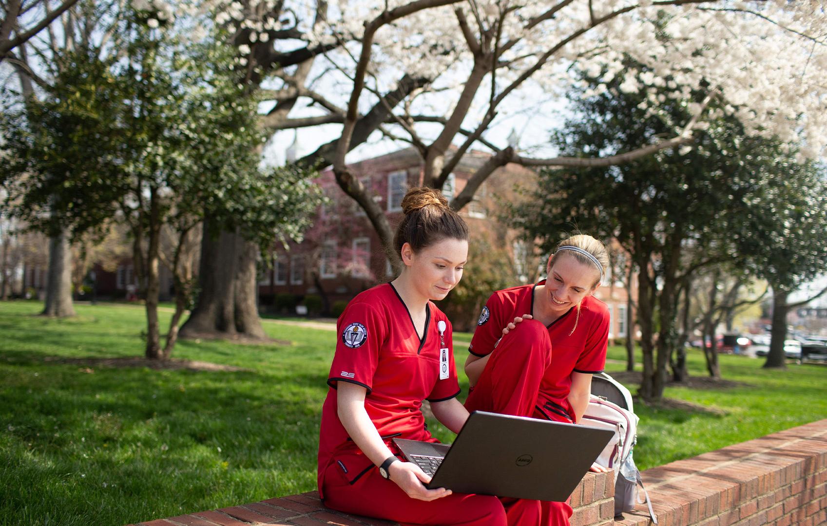 nurses look at laptop